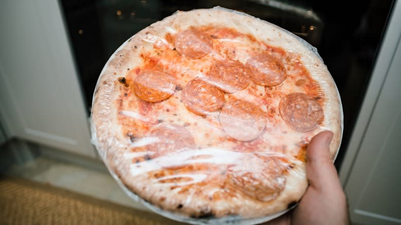 frozen pizza in cellophane wrapper