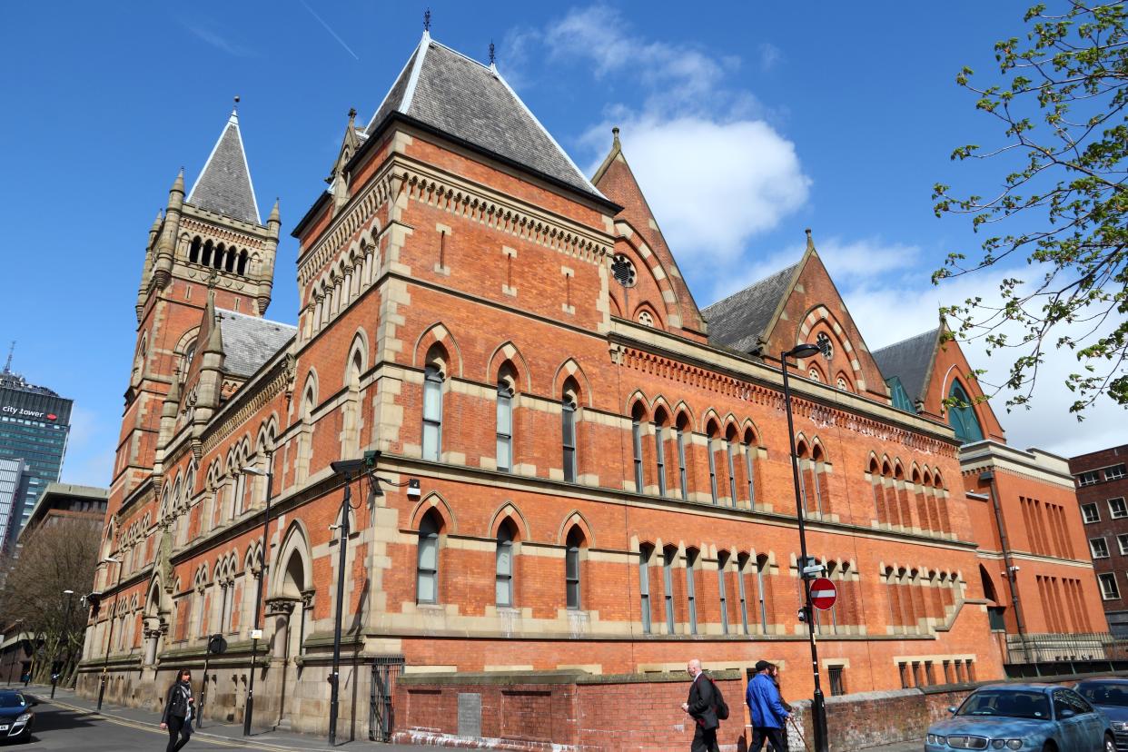 People visit City Police Courts in Manchester, UK. The old landmark is a Grade II listed building.