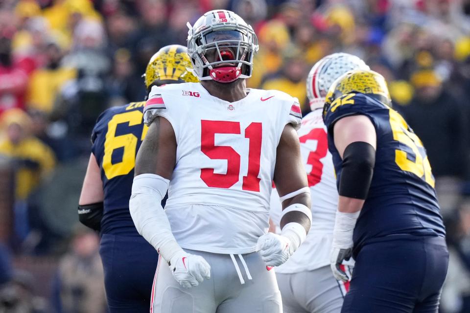 Nov 25, 2023; Ann Arbor, Michigan, USA; Ohio State Buckeyes defensive tackle Michael Hall Jr. (51) celebrates a sack of Michigan Wolverines quarterback <a class="link " href="https://sports.yahoo.com/ncaaf/players/322778/" data-i13n="sec:content-canvas;subsec:anchor_text;elm:context_link" data-ylk="slk:J.J. McCarthy;sec:content-canvas;subsec:anchor_text;elm:context_link;itc:0">J.J. McCarthy</a> (9) during the first half of the NCAA football game at Michigan Stadium.
