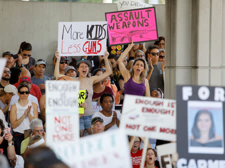 Protesters hold signs at a rally calling for more gun control three days after the shooting at Marjory Stoneman Douglas High School, in Fort Lauderdale, Florida, U.S., February 17, 2018. REUTERS/Jonathan Drake