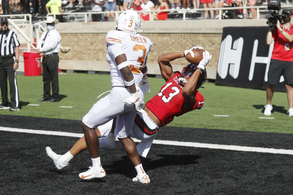 Texas Tech wide receiver Erik Ezukanma makes a diving catch in the end zone for a touchdown covered by Texas defensive back Jaklen Green during the first half of an NCAA college football game against Texas Tech, Saturday Sept. 26, 2020, in Lubbock, Texas. (AP Photo/Mark Rogers)