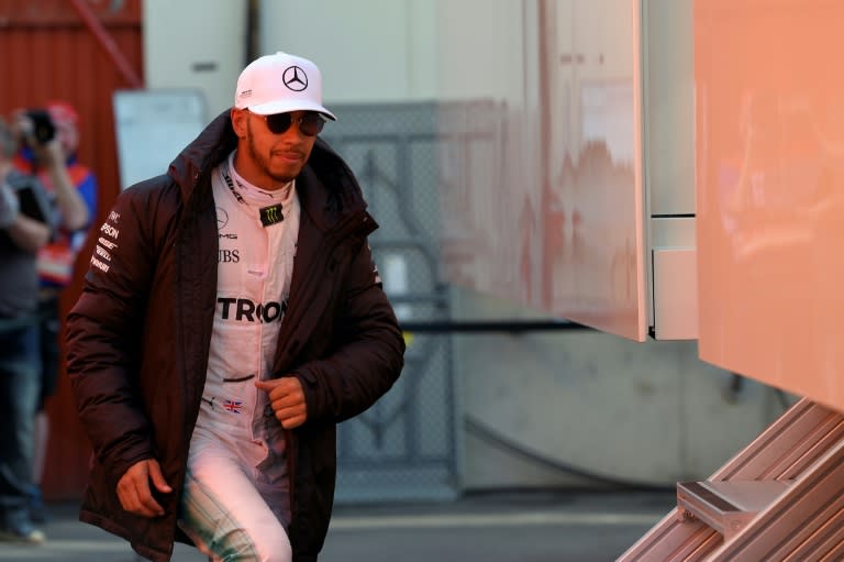 Mercedes driver Lewis Hamilton walks at the Circuit de Catalunya on March 9, 2017 on the outskirts of Barcelona during tests ahead of the Formula One Grand Prix season