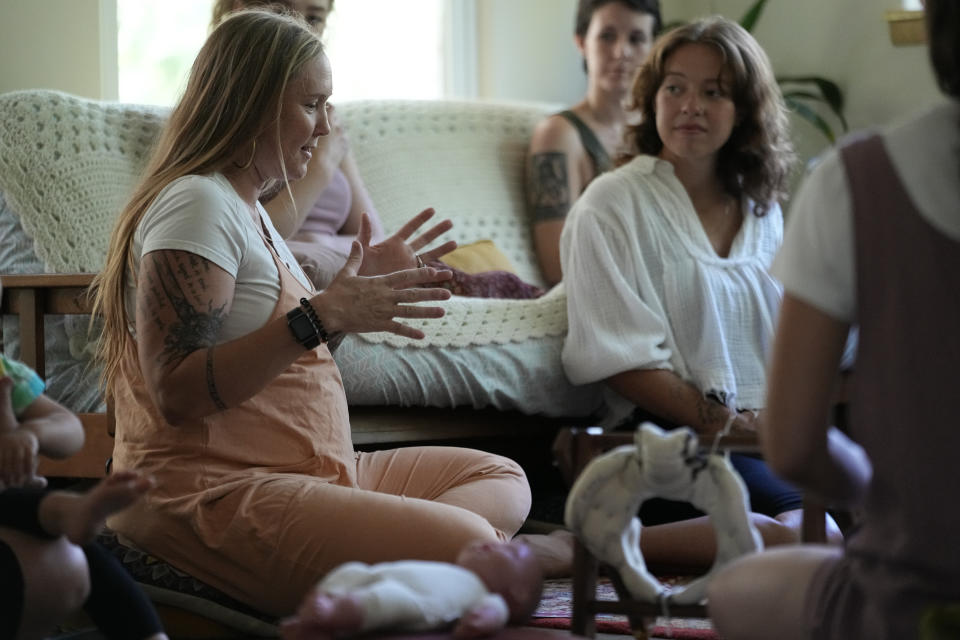 Betsy Baarspul, left, speaks during a prenatal group meeting at The Farm Midwifery Center, Thursday, Aug. 31, 2023, in Summertown, Tenn. Baarspul, of Nashville, said she had an emergency C-section in a hospital for her first child. She’s now pregnant with her third, and described the difference between hospital care and birth center care as “night and day.” “This is the perfect place for me,” she said. “It feels like you’re held in a way.” (AP Photo/George Walker IV)