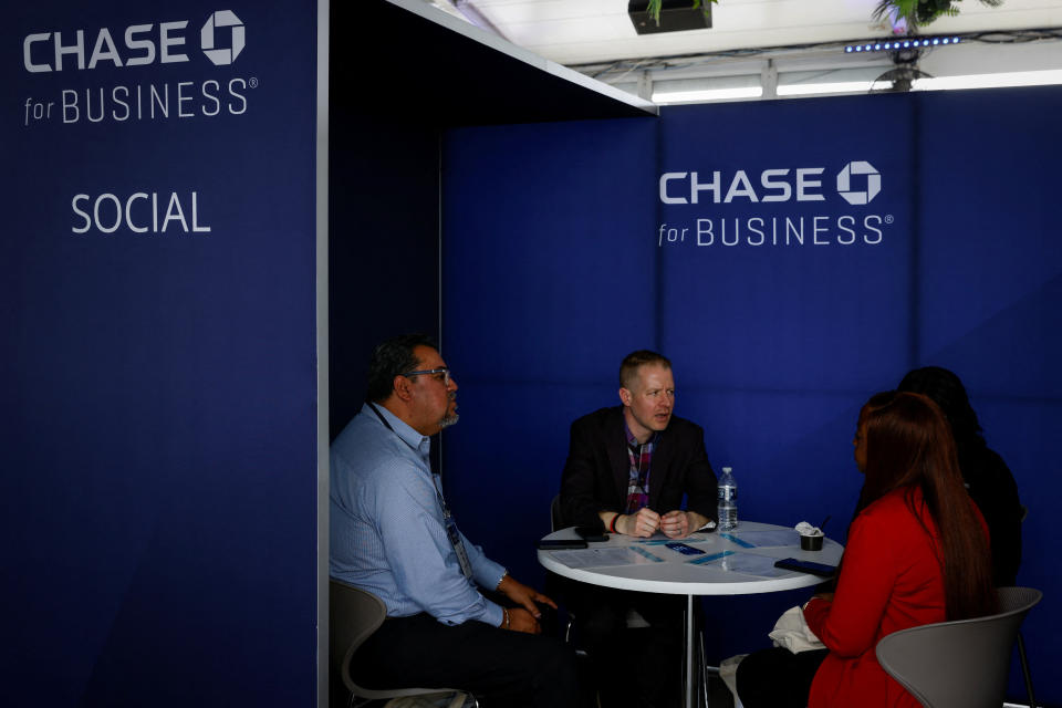 Attendees talk with a representative during the event Chase for Business The Experience - Miami hosted by JP Morgan Chase Bank for small business owners at The Wharf, in Miami, Florida, U.S., February 8, 2023. REUTERS/Marco Bello