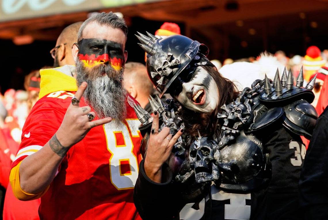 A Kansas City Chiefs fan and a Las Vegas Raiders fan pose for a photo during a game last season at GEHA Field at Arrowhead Stadium.