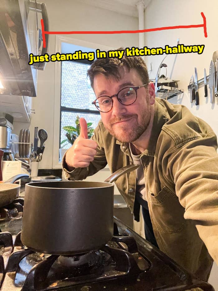 Author standing in narrow kitchen with text "just standing in my kitchen hallway"