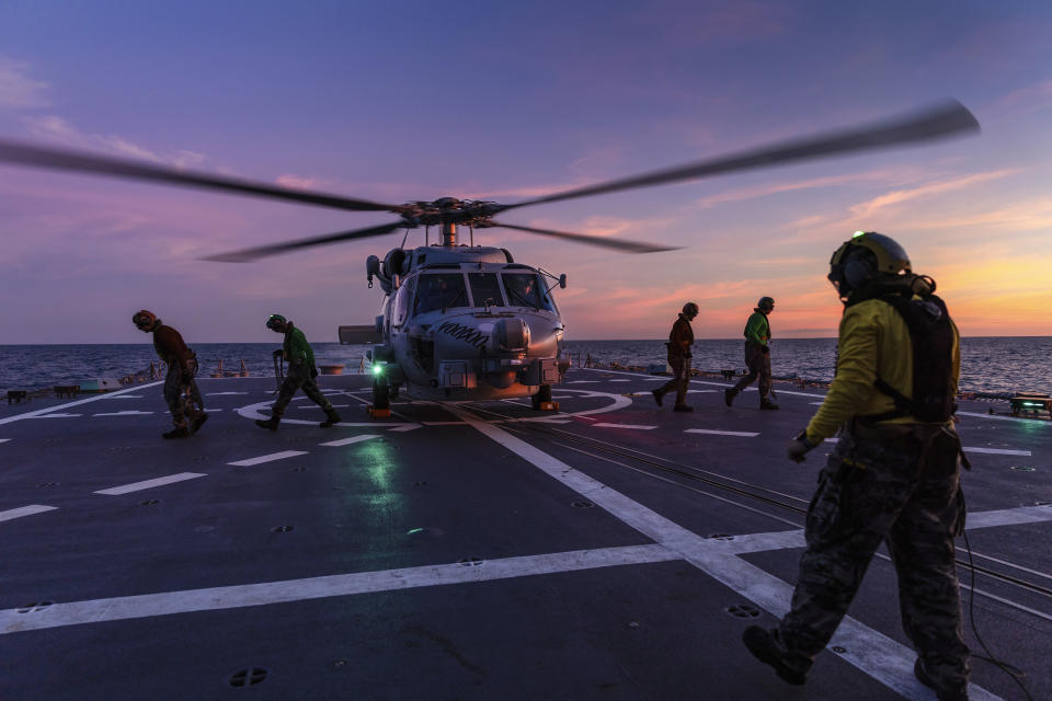 In this undated photo provided by the Australian Defence Force, a Seahawk helicopter prepares to take off from the deck of HMAS Hobart during flying operations while on a regional presence deployment off northern Australia. Australia has protested to Beijing through multiple channels that a Chinese fighter jet endangered an Australian navy helicopter with flares over international waters, the prime minister said Tuesday, May 7, 2024. (LSIS Matthew Lyall/Australian Defence Force via AP)