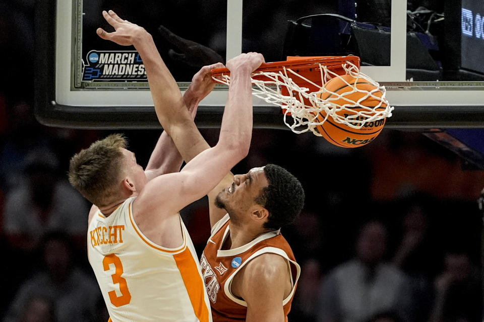 Tennessee guard Dalton Knecht (3) dunks the ball against Texas forward Dylan Disu (1) during the second half of a second-round college basketball game in the NCAA Tournament, Saturday, March 23, 2024, in Charlotte, N.C. (AP Photo/Mike Stewart)