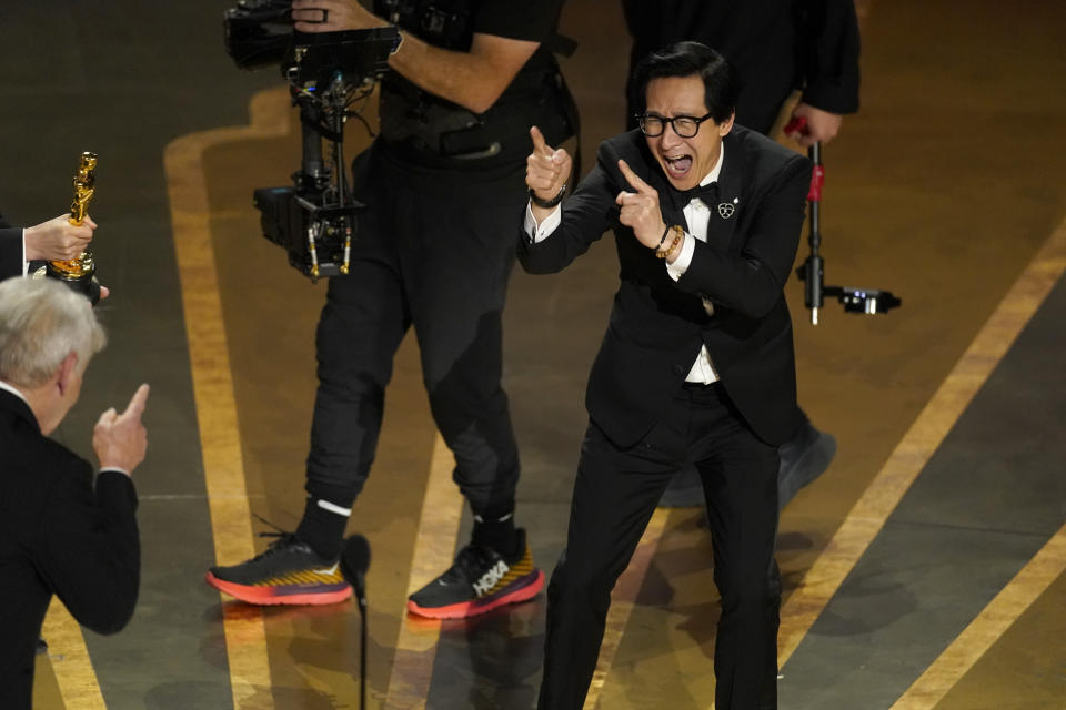 Harrison Ford, left, and Ke Huy Quan react onstage when "Everything Everywhere All at Once" wins the award for best picture at the Oscars on Sunday, March 12, 2023, at the Dolby Theatre in Los Angeles. (AP Photo/Chris Pizzello)