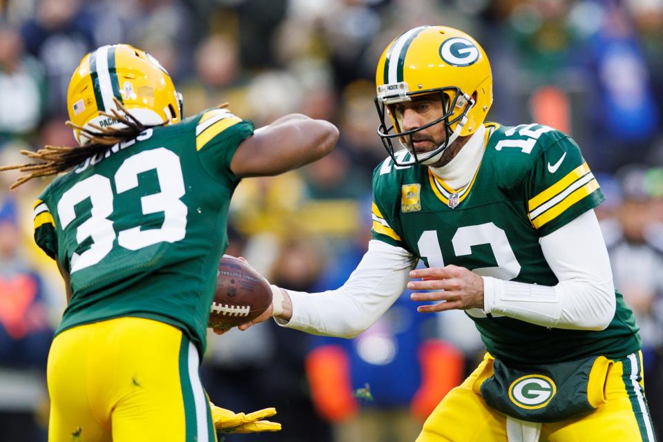 Nov 13, 2022; Green Bay, Wisconsin, USA;  Green Bay Packers quarterback Aaron Rodgers (12) hands the ball off to Green Bay Packers running back Aaron Jones (33) during the first quarter against the Dallas Cowboys at Lambeau Field. Mandatory Credit: Jeff Hanisch-USA TODAY Sports