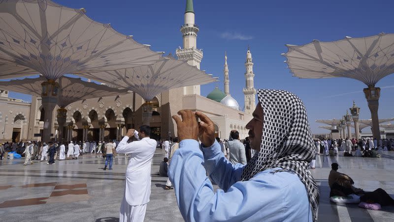 Worshippers take a photo of the Prophet Muhammad’s Mosque, the second holiest site in Islam, in the Saudi holy city of Medina, Monday, March 7, 2016.