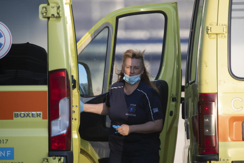 A medic gets out of an ambulance parked near the Mein Schiff 6 cruise ship as the ship is docked at Piraeus port, near Athens on Tuesday, Sept. 29, 2020. Greek authorities say 12 crew members on a Maltese-flagged cruise ship carrying more than 1,500 people on a Greek islands tour have tested positive for coronavirus and have been isolated on board. (AP Photo/Petros Giannakouris)