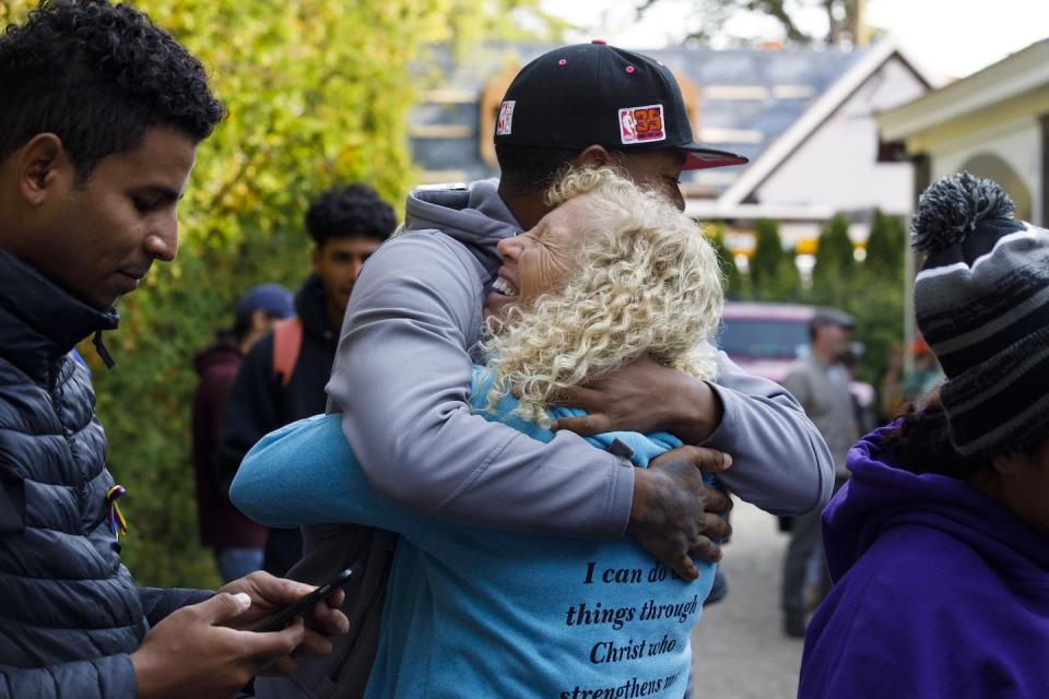 A volunteer hugs a Venezuelan migrant outside of a church on Martha’s Vineyard on Sept. 16, 2022. <a href="https://media.gettyimages.com/photos/lisa-belcastro-a-volunteer-embraces-rafael-a-venezuelan-migrant-of-picture-id1243368410" rel="nofollow noopener" target="_blank" data-ylk="slk:Carlin Stiehl for the Boston Globe via Getty Images;elm:context_link;itc:0;sec:content-canvas" class="link ">Carlin Stiehl for the Boston Globe via Getty Images</a>