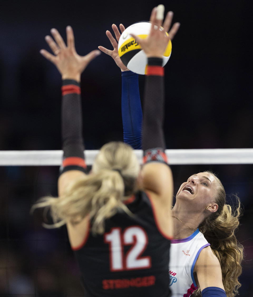 Omaha Supernovas' Brooke Nuneville, right, hits over the net against Atlanta Vibe's Tori Stringer during a Pro Volleyball Federation game Wednesday, Jan. 24, 2024, in Omaha, Neb. (AP Photo/Rebecca S. Gratz)