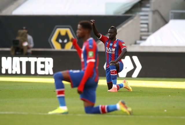 Wilfried Zaha takes a knee for Black Lives Matter prior to a Premier League game 