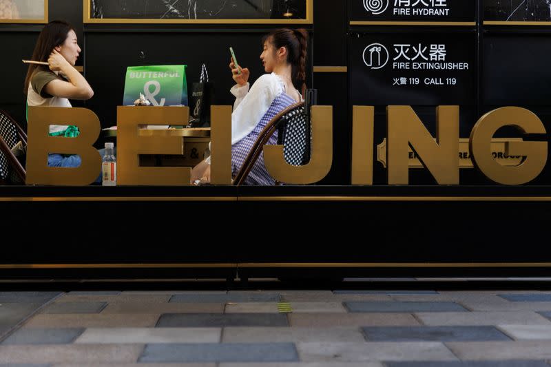 Women sit in a cafe in a shopping area in Beijing