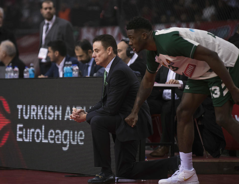 Panathinaikos coach Rick Pitino, left, looks on next to player Thanasis Antetokounmpo, right, during a Euroleague basketball match between Panathinaikos and Olympiakos in Piraeus near Athens, on Friday, Jan. 4, 2019. (AP Photo/Petros Giannakouris)