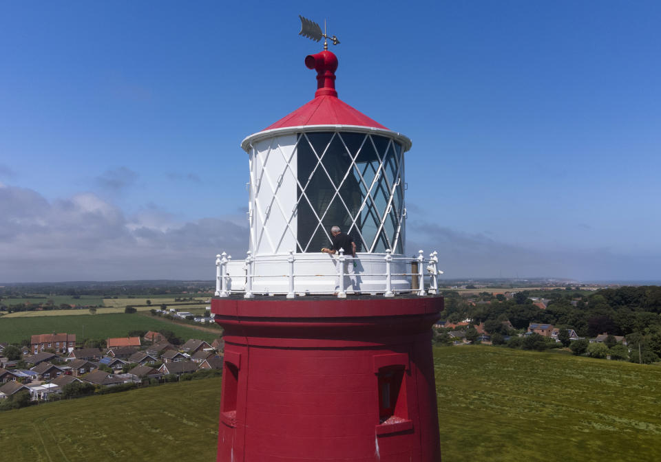 <p>The windows on the lantern room are cleaned at Happisburgh Lighthouse in Happisburgh on the North Norfolk coast as it prepares to reopen to visitors after being closed since 2019 due to the Coronavirus pandemic. Picture date: Thursday July 15, 2021.</p>
