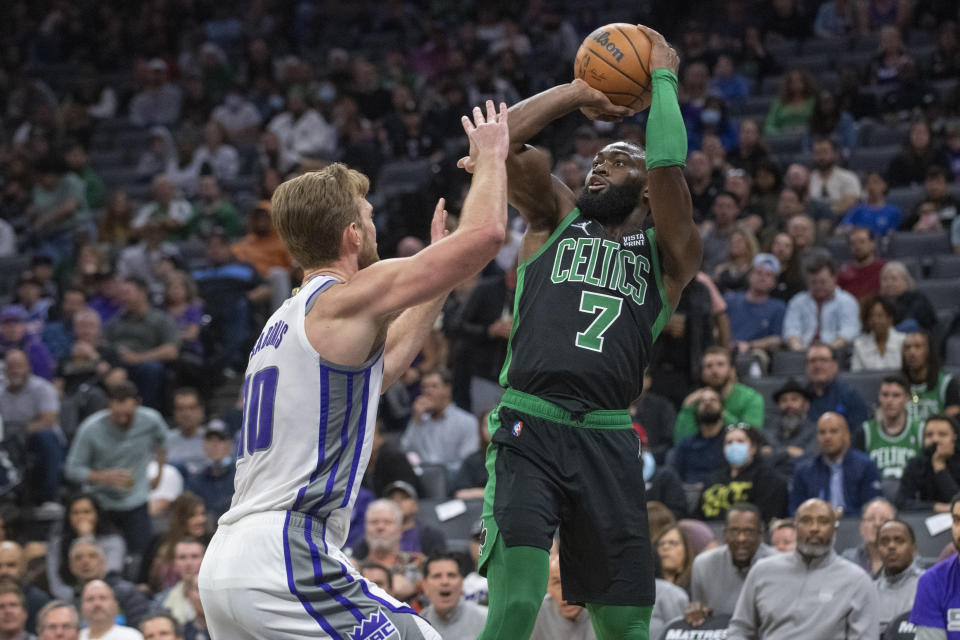 Boston Celtics guard Jaylen Brown (7) shoots over Sacramento Kings forward Domantas Sabonis (10) during the first quarter of an NBA basketball game in Sacramento, Calif., Friday, March 18, 2022. (AP Photo/Randall Benton)