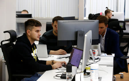 Employees of VP Capital, one of the companies which launched a platform allowing traders to buy shares, gold, foreign exchange and other traditional assets with cryptocurrencies, work at an office in Minsk, Belarus January 15, 2019. REUTERS/Vasily Fedosenko