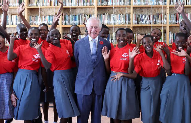 <p>Chris Jackson/Getty</p> King Charles meets young people during his visit to Eastlands Library with Queen Camilla on October 31.