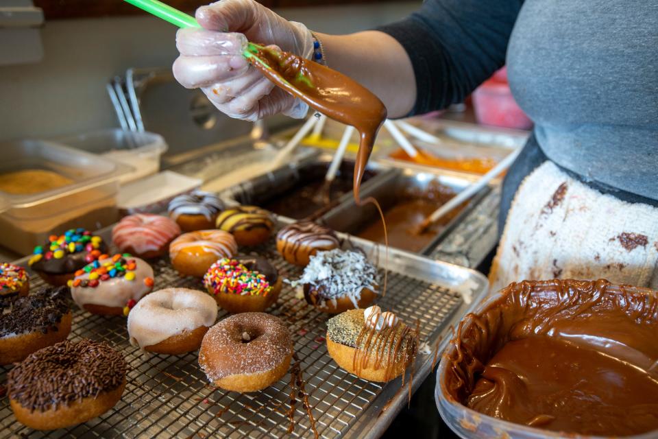 Cameron Oakley of Lincroft, doughnut artist, decorates an assortment of doughnuts at the Broad Street Dough Co. in Ocean Twp., NJ Tuesday, January 12, 2021.