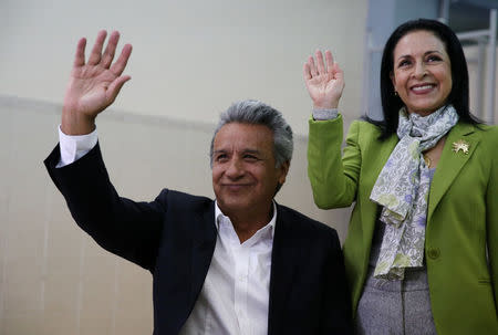 Government candidate Lenin Moreno (L) and his wife Rocio Gonzalez wave after Moreno casted his vote during the presidential election in Quito, Ecuador April 2, 2017. REUTERS/Mariana Bazo