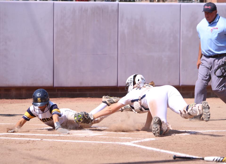 Hartland catcher Sadie Malik tags out South Lyon's Olivia Simeone at the plate during a state Division 1 quarterfinal softball game Tuesday, June 11, 2024 at Albion College.