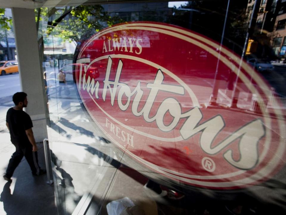  A pedestrian walks past a Tim Hortons restaurant in downtown Vancouver.