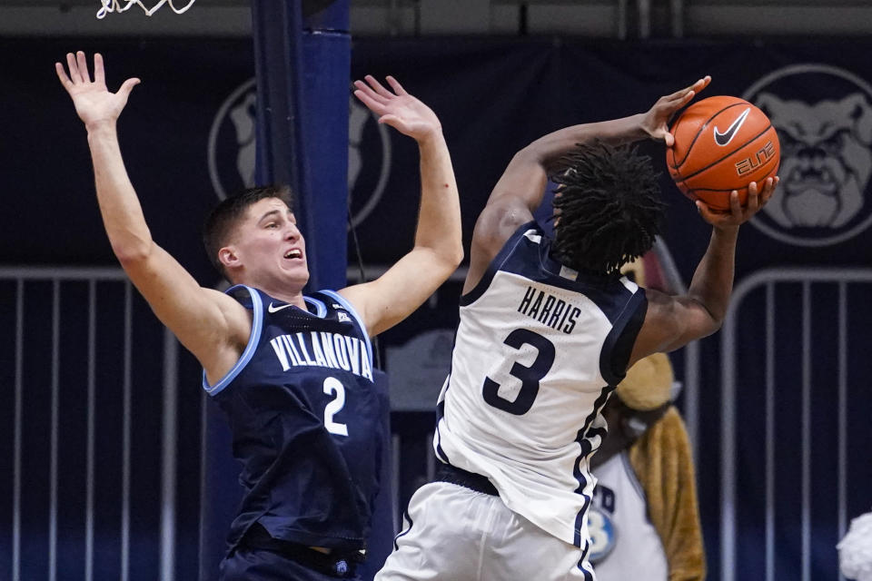 Butler guard Chuck Harris (3) shoots over Villanova guard Collin Gillespie (2) in the first half of an NCAA college basketball game in Indianapolis, Sunday, Feb. 28, 2021. (AP Photo/Michael Conroy)