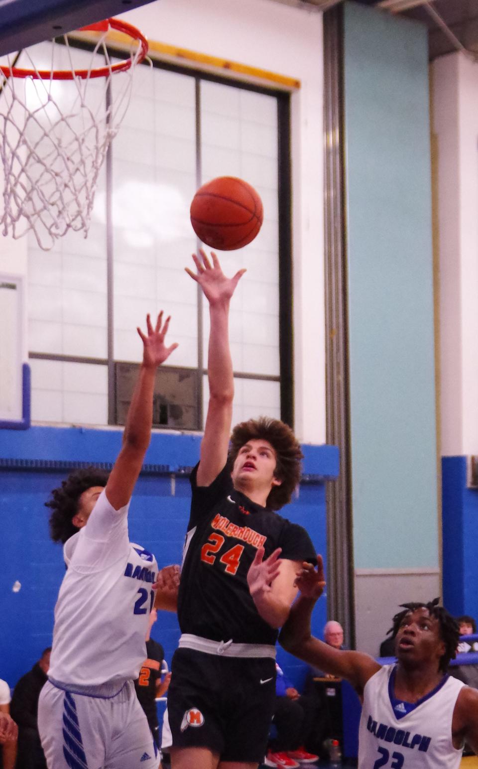 Despite being surrounded by Randolph defenders, Middleboro's Jackson Davenport goes up strong for a shot in the 1st half of the game on Friday, Dec. 15, 2023.