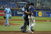 Tampa Bay Rays' Kevin Kiermaier, right, is held back by home plate umpire Bruce Dreckman and Toronto Blue Jays catcher Danny Jansen after Kiermaier was hit with a pitch by starting pitcher Ryan Borucki, right, during the eighth inning of a baseball game Wednesday, Sept. 22, 2021, in St. Petersburg, Fla. (AP Photo/Chris O'Meara)