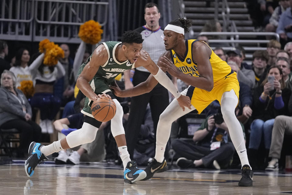 Milwaukee Bucks' Giannis Antetokounmpo (34) goes to the basket against Indiana Pacers' Myles Turner (33) during the first half of an NBA basketball game, Friday, Jan. 27, 2023, in Indianapolis. (AP Photo/Darron Cummings)