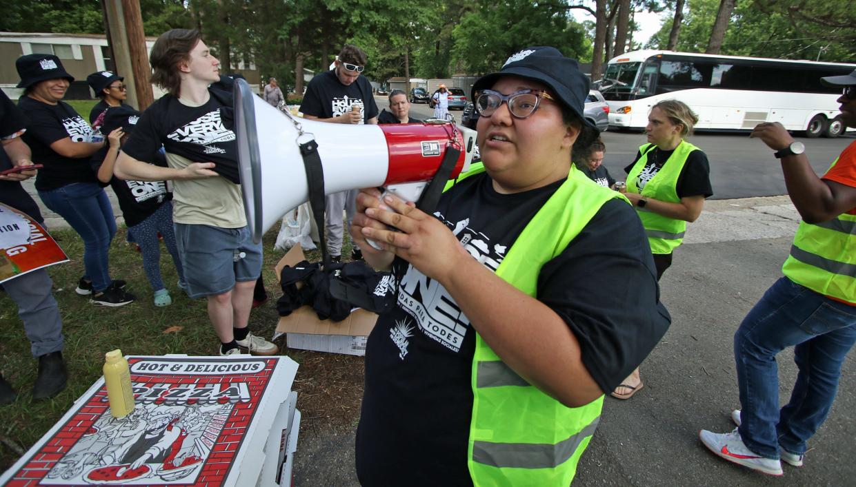 Jessica Moreno talks to protesters using a megaphone as they gather to protest in front of Charlotte Hill Mobile Home Park in Charlotte Monday afternoon, June 10, 2024.