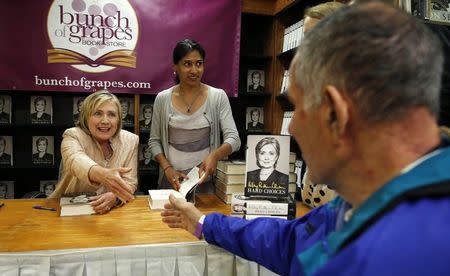 Hillary Clinton shakes hands with a man during a signing session for her book "Hard Choices" at the Bunch of Grapes bookstore in Vineyard Haven on Martha's Vineyard, Massachusetts August 13, 2014. REUTERS/Kevin Lamarque