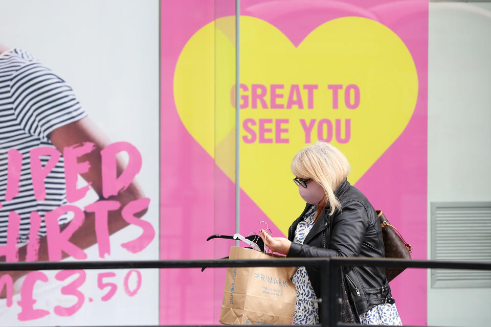 MANCHESTER, UNITED KINGDOM - MAY 13: A woman is seen wearing a face mask outside non-essential retail store Primark on May 13, 2021 in Manchester, United Kingdom. (Photo by Charlotte Tattersall/Getty Images)