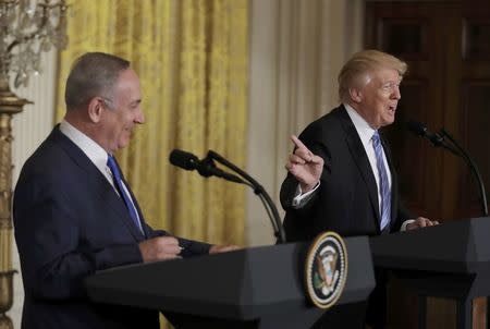 U.S. President Donald Trump (R) laughs with Israeli Prime Minister Benjamin Netanyahu at a joint news conference at the White House in Washington, U.S., February 15, 2017. REUTERS/Kevin Lamarque