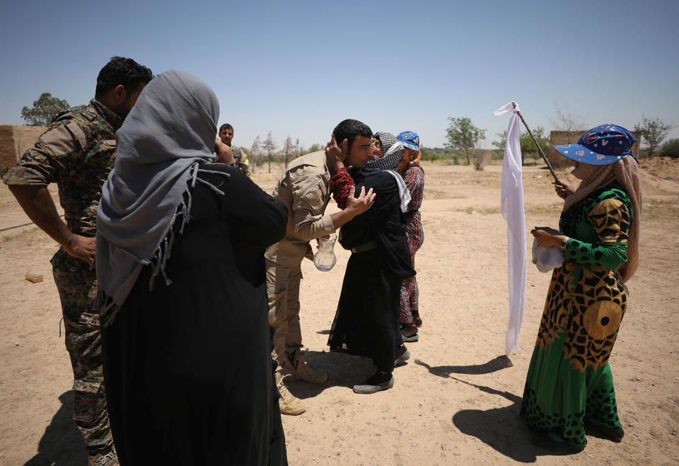 <p>A woman, who fled with others from an Islamic State-controlled area, greets Syrian Democratic Forces (SDF) fighters near Raqqa city, Syria June 7, 2017. (Photo: Rodi Said/Reuters) </p>