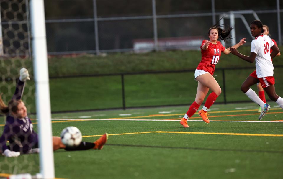 Bridgewater-Raynham's Haylie Fortune scores a goal on New Bedford goalkeeper Caitlyn Cordeiro during a game on Tuesday, Oct. 10, 2023.