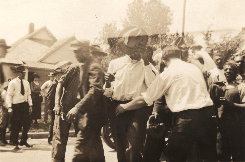 African-American men being detained and led down a residential street on June 1, 1921 in Tulsa, Okla. (Department of Special Collections, McFarlin Library, The University of Tulsa)