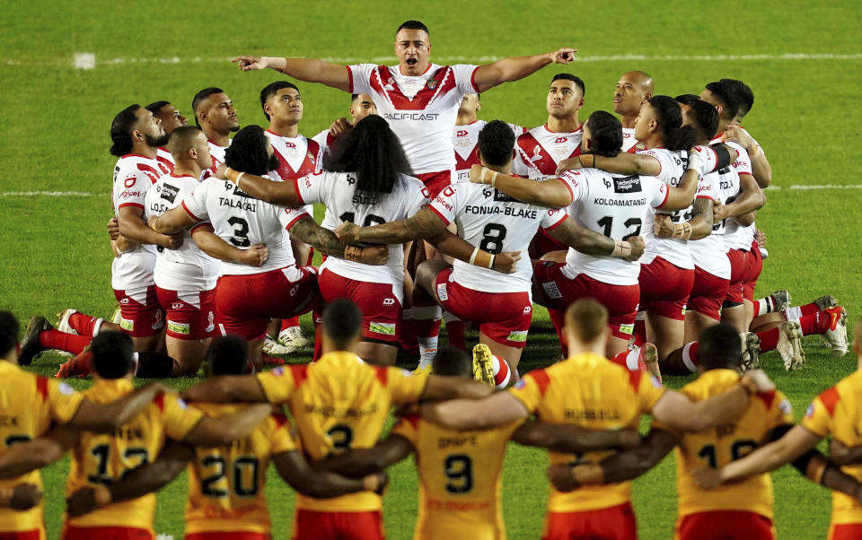 Tonga preform their pre match war dance, ahead of the Rugby League World Cup group D match between Tonga and Papua New Guinea at Totally Wicked Stadium, in St Helens, Merseyside, England, Tuesday, Oct. 18, 2022. (Martin Rickett/PA via AP)