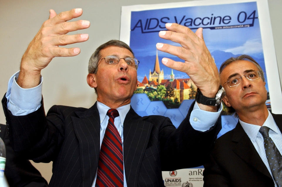 FILE - Anthony Fauci, left, director of the U.S. National Institute of Allergy and Infectious Diseases, speaks near Giuseppe Pantaleo, right, chairman of the AIDS Vaccine 04 conference and professor at Lausanne University Hospital, CHUV, during a news conference after the opening of the AIDS Vaccine 04 conference in Lausanne, Switzerland, on Aug. 30, 2004. Fauci steps down from a five-decade career in public service at the end of the month, one shaped by the HIV pandemic early on and the COVID-19 pandemic at the end. (AP Photo/Keystone, Laurent Gillieron, File)