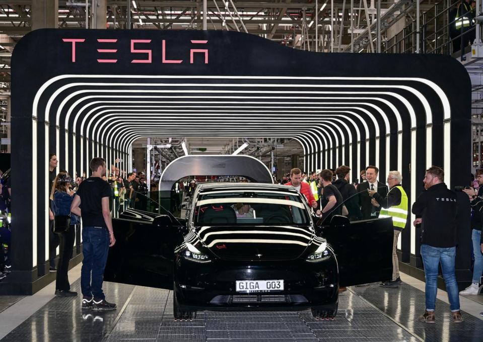 PHOTO: Elon Musk hands over a Model Y car to a customer during the opening ceremony of the new Tesla Gigafactory for electric cars in Gruenheide, Germany, March 22, 2022.  (Patrick Pleul/Pool via Reuters, FILE)