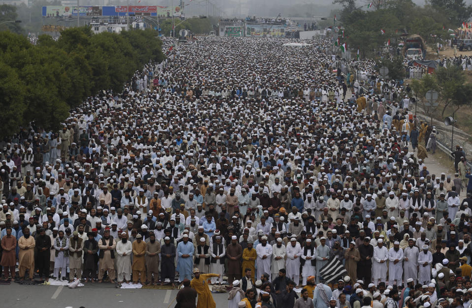 Supporters of a Pakistani radical Islamist party 'Jamiat Ulema-e-Islam' offer prayers during an anti-government march, in Islamabad, Pakistan, Friday, Nov. 1, 2019. Thousands of members of a radical Islamist party have camped out in Pakistan's capital, demanding the resignation of Prime Minister Imran Khan over economic hardships. (AP Photo/Anjum Naveed)