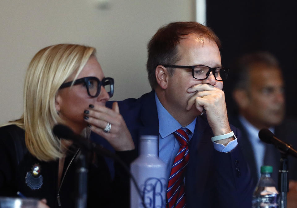 Florida Senator Lauren Book, left, and Ryan Petty, the father of shooting victim Alaina Petty listen to videos from the school shooting during the Marjory Stoneman Douglas High School Public Safety Commission meeting Thursday, Nov. 15, 2018, in Sunrise, Fla. (AP Photo/Brynn Anderson)