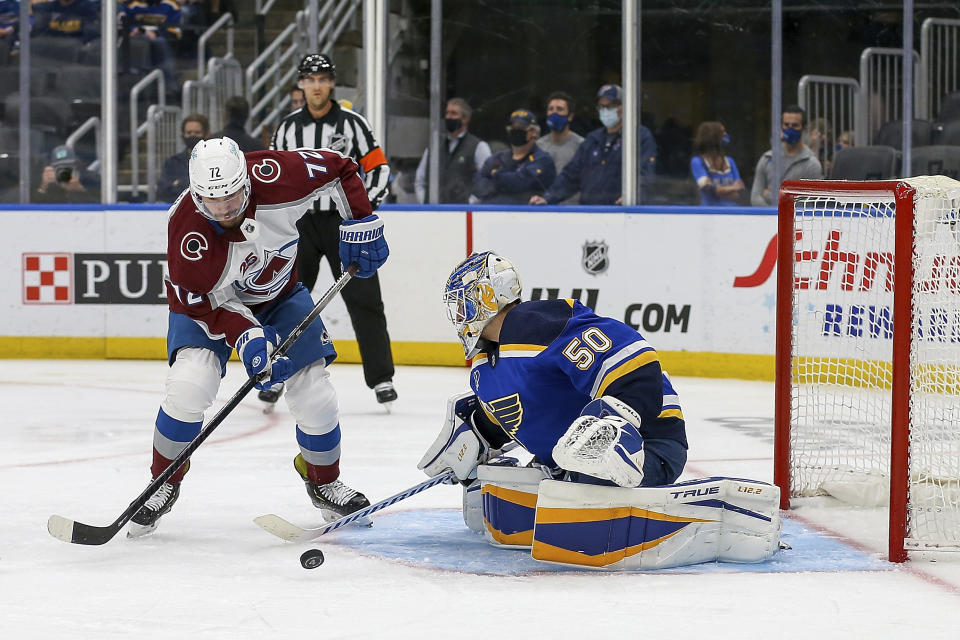 St. Louis Blues goaltender Jordan Binnington (50) stops Colorado Avalanche's Joonas Donskoi (72) from shooting during the third period in Game 3 of an NHL hockey Stanley Cup first-round playoff series Friday, May 21, 2021, in St. Louis. (AP Photo/Scott Kane)