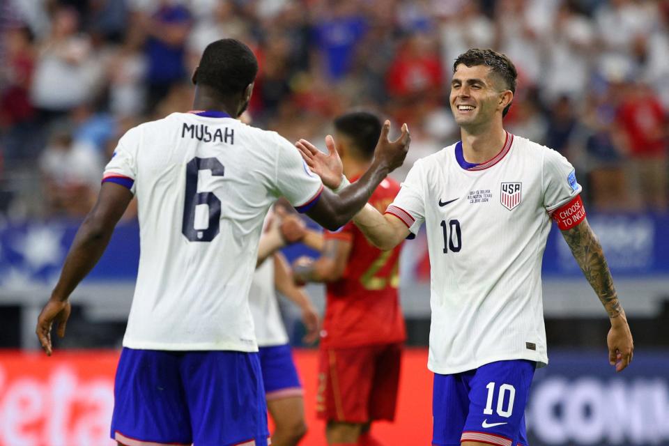 USA's midfielder #06 Yunus Musah and USA's forward #10 Christian Pulisic greet each other after their victory in the Conmebol 2024 Copa America tournament group C football match between the USA and Bolivia at AT&T Stadium in Arlington, Texas on June 23, 2024. (Photo by Aric Becker / AFP) (Photo by ARIC BECKER/AFP via Getty Images)