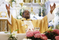 Father Ako Walker leads Easter Mass at Sacred Heart of Jesus and Saint Patrick, Sunday, March 31, 2024, in Baltimore, Md. (AP Photo/Julia Nikhinson)