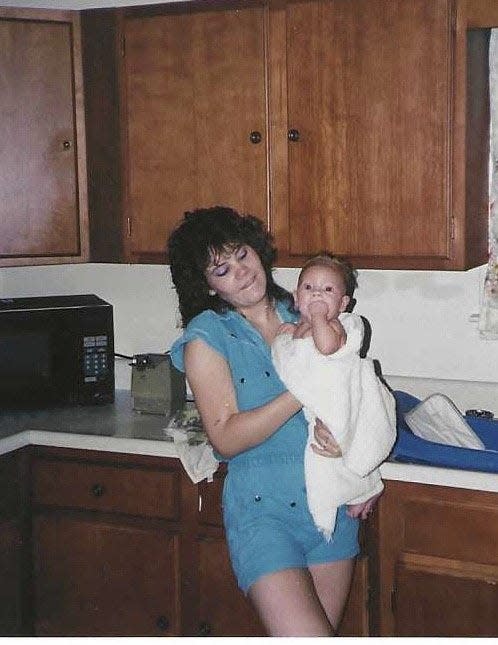 Katelin Puzakulics being held by her mother, Rachael Johnson, who was killed in 1991. [Submitted Photo]