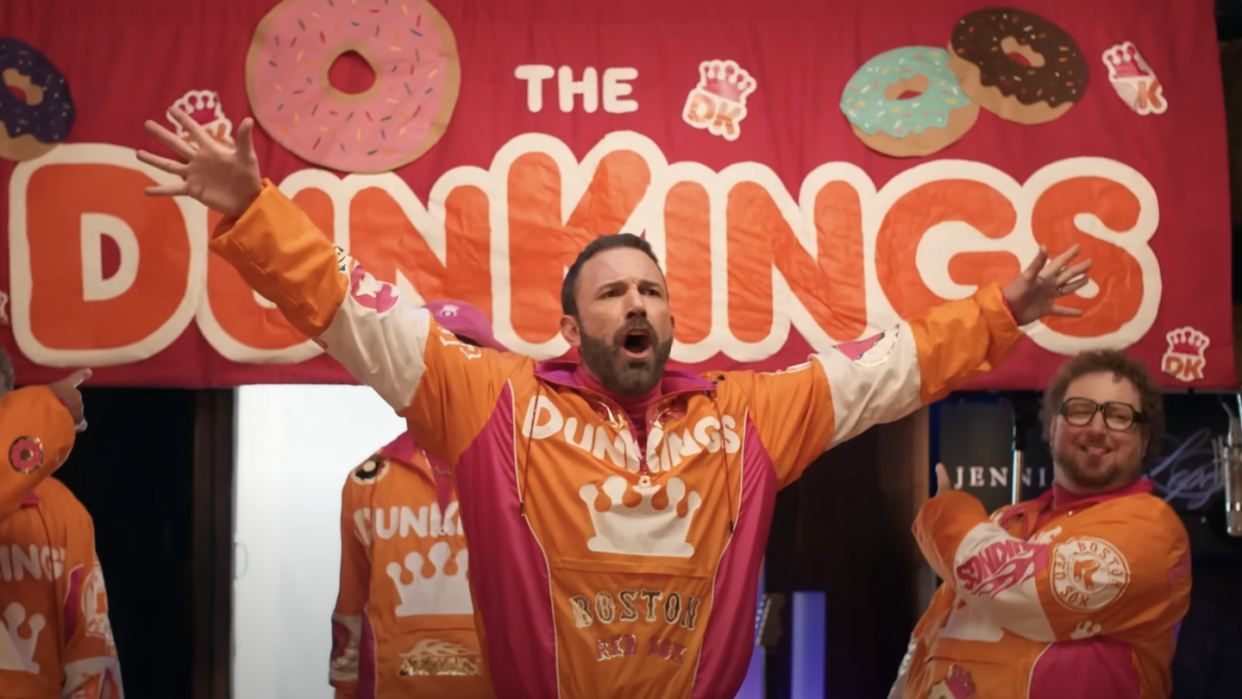 a group of men in orange shirts